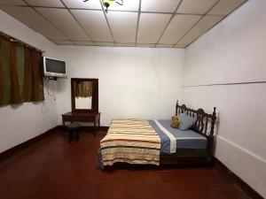 Postel nebo postele na pokoji v ubytování Hostal Casa Alta