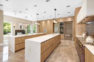 eine große Küche mit Holzschränken und einer Arbeitsplatte in der Unterkunft The Polished Pearl Estate — Luxe Retreat/Pool/Spa in Saddle River
