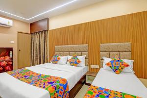 two beds in a hotel room with at Hotel RA Apartment in Chennai