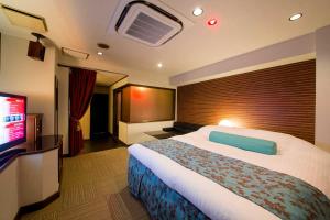 Postel nebo postele na pokoji v ubytování 大垣ホテルヴィヴィ