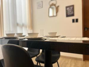 a table with chairs and plates on top of it at Excelente ubicación, cálido, siéntete en casa in La Paz