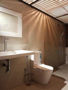 a bathroom with a toilet and a sink at Mahagedara Dickwella in Dickwella +55 photos