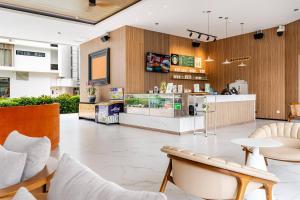 a lobby of a restaurant with a counter and chairs at Laya Resort -Tropical Studio in Layan Beach