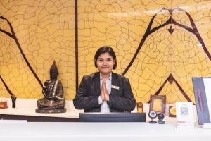 a woman sitting at a table with her arms crossed at Siddhartha Diyalo in Bīrganj