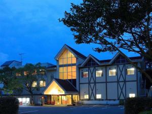 a large building with a lot of windows at night at Hotel SP Haruno in Shinkawa