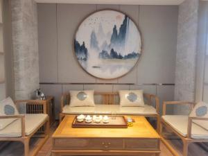 una habitación con dos mesas y dos sillas y un espejo en Qingdao Likelai Garden Hotel, en Qingdao