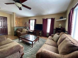 a living room with a couch and a coffee table at Spacious & Practical 4 Bed Home in Sudbury