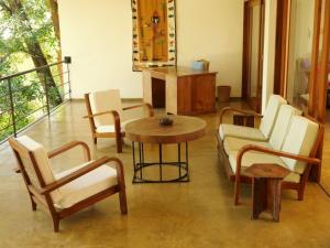 a living room with chairs and a table and a table at The Heights in Asgiriya in Kandy