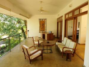 a living room with a couch and chairs and a table at The Heights in Asgiriya in Kandy