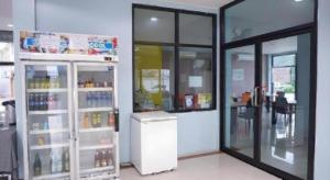 a room with a refrigerator in a store at C2U Hotel Uthai Thani in Ban Khok Mo