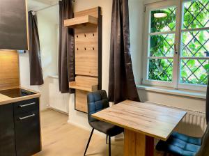 a kitchen with a wooden table and a window at Modern Old Town Studio in Hall in Tirol