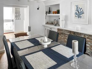 a dining room table with two chairs and a fireplace at Shearwaters in Saint Mawes