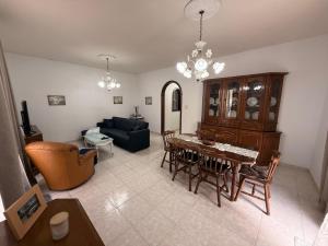 a living room with a table and a couch at Ta Mary Apartment A Perfect St Pauls Bay Base in St Paul's Bay