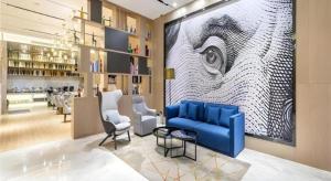 eine Lobby mit einem blauen Sofa und Stühlen sowie einer Bar in der Unterkunft Echarm Hotel Kunming Railway Station Huancheng South Road Metro Station in Kunming