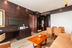 a living room with a couch and a television at Siddhartha Diyalo in Bīrganj +18 photos