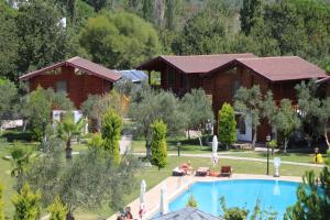 a resort with a pool and a cabin at Hotel Sunset Troia in Dalyanköy