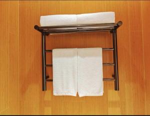 a towel rack with two towels on it in a bathroom at All Seasons Beijing Capital Airport Liqiao Hotel in Beijing