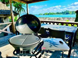 a grill sitting on top of a table on a deck at okinawa海宿は海まで徒歩15歩の1棟貸でBBQ可能 in Nakijin