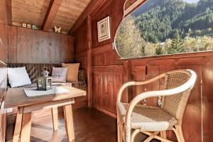 a room with a table and chairs and a window at Apart Fortuna in See