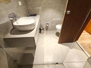 a bathroom with a sink and a toilet at Ricch Hotels in Hyderabad
