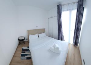 a bedroom with a white bed with a hat on it at Cozy nest in Tatu City