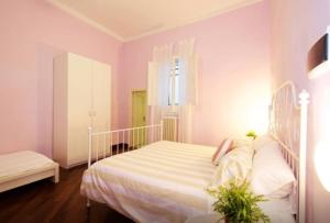 a bedroom with a white bed and a window at Una Piacevole Sorpresa in Bari