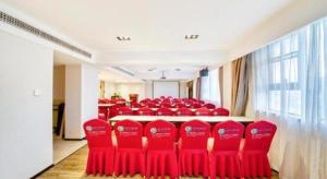 a conference room with red chairs in the middle at City Comfort Inn Kunshan High-speed Railway Station Renmin Road in Kunshan