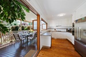 a kitchen with a table and chairs on a balcony at A Market Place Mudgee - Walk to Town Centre & Parks in Mudgee