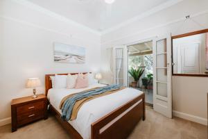 a bedroom with a large bed and a window at A Market Place Mudgee - Walk to Town Centre & Parks in Mudgee