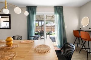 a dining room with a wooden table with chairs at Heated Saltwater Pool I Old Town I BBQ I Firepit in Scottsdale