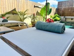 a blue pillow sitting on top of a table at Villa Familly in Saint-Paul