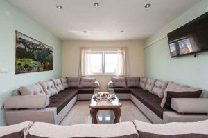 a living room with a large couch and a table at Holiday home in Sevid 36049 in Zaglavice