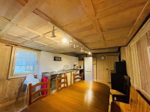 a room with a table and a kitchen with a counter at Ferienhaus Unteraxen in Sisikon +12 photos