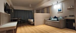 a living room with a couch and a table at SILVER INN, Andheri in Mumbai +9 photos