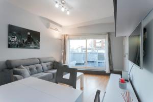 a living room with a couch and a table at Apartment Cardenal Cisneros in Madrid