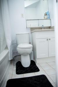 a bathroom with a toilet and a sink and a mirror at The Idea in Toronto
