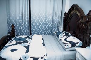 a bedroom with a bed with black and white sheets at The Idea in Toronto +15 photos