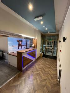 a room with a large screen in the middle of a room at White Rose Hotel & Restaurant - Leeds in Leeds