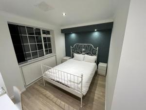 a small bedroom with a white bed and a window at White Rose Hotel & Restaurant - Leeds in Leeds