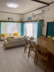 a living room with a couch and a table at Lagoon藍yoron 一棟貸し in Yoron