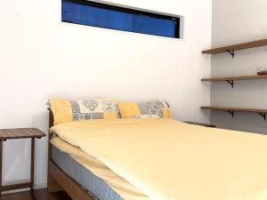 a bedroom with a bed and a window at The Ogawa 小川 Live like a local in Inzai