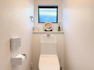 a small bathroom with a toilet and a window at The Ogawa 小川 Live like a local in Inzai +36 photos