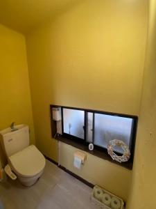 a bathroom with a toilet and a window at Lagoon藍yoron 一棟貸し in Yoron +9 photos