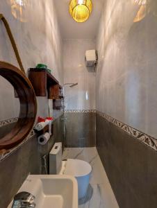 a bathroom with a sink and a toilet and a mirror at Villa Goli Paje in Paje