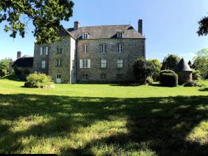 an old stone house on a grassy field at Séjour romantique ou professionnel au Château isigny, Charme et feu de cheminée in Isigny-le-Buat +50 photos
