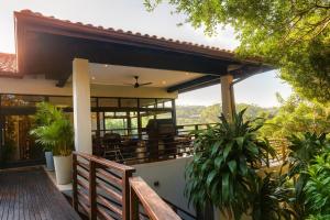 a house with a balcony with a view at Zimbali Emerald Eden in Ballito