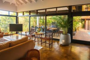 a living room with a couch and a table and chairs at Zimbali Emerald Eden in Ballito