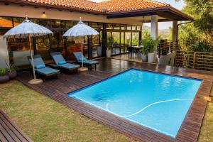a swimming pool in the yard of a house at Zimbali Emerald Eden in Ballito