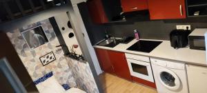 a small kitchen with a sink and a washing machine at Studio propre disponible in Vigneux-sur-Seine