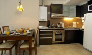 a kitchen with a table and a kitchen with a dining room at Village Condo in San Carlos de Bariloche +26 photos